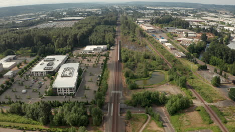 Aerial-follow-shot-over-Amtrack-train-traveling-through-suburban-america