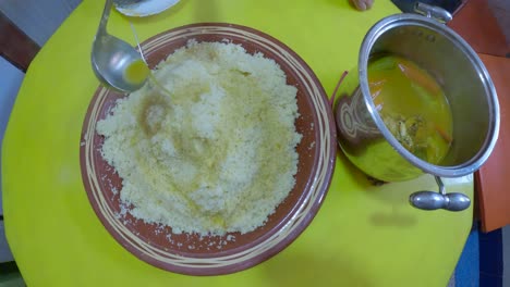 moroccan woman is serving traditional moroccan couscous