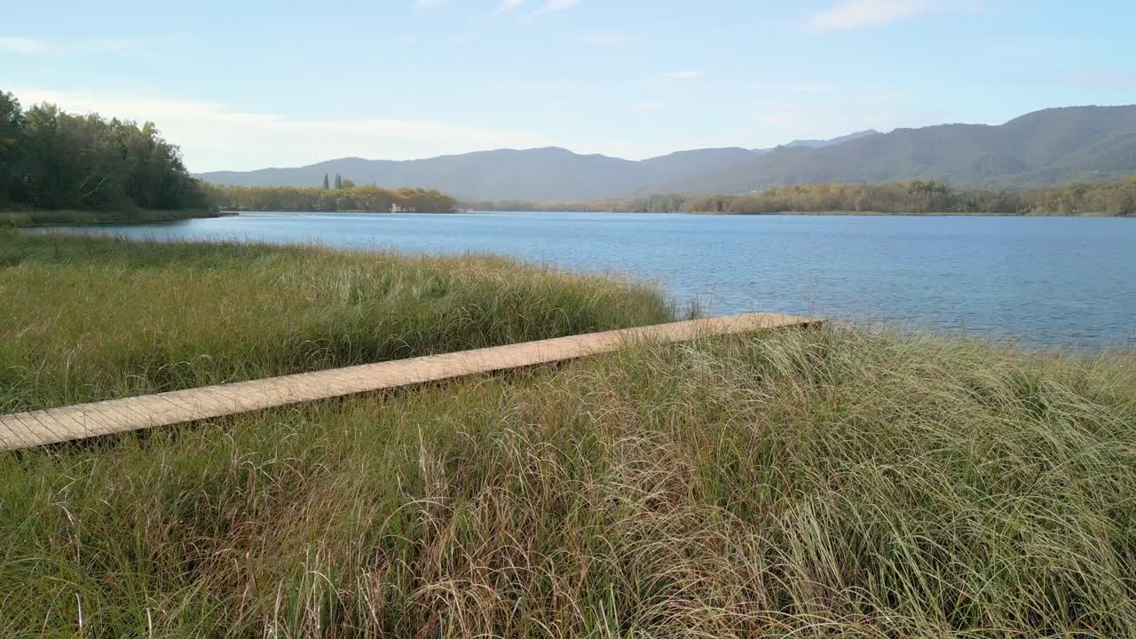 Serene Lake with Wooden Dock and Mountain View