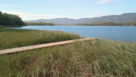 serene lake with wooden dock and mountain view