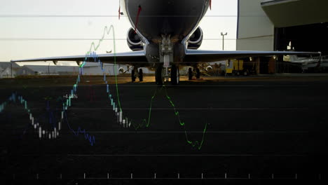 financial graph animation overlaying airplane on tarmac at airport runway