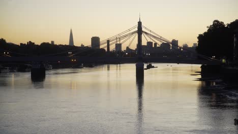 london dawn skyline reflected in thames featuring albert bridge and battersea bank 4k