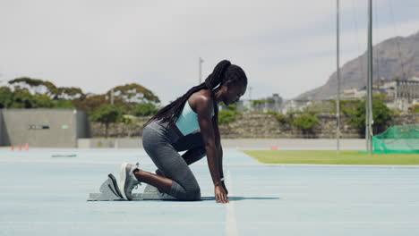 runner in starting position with feet on angled