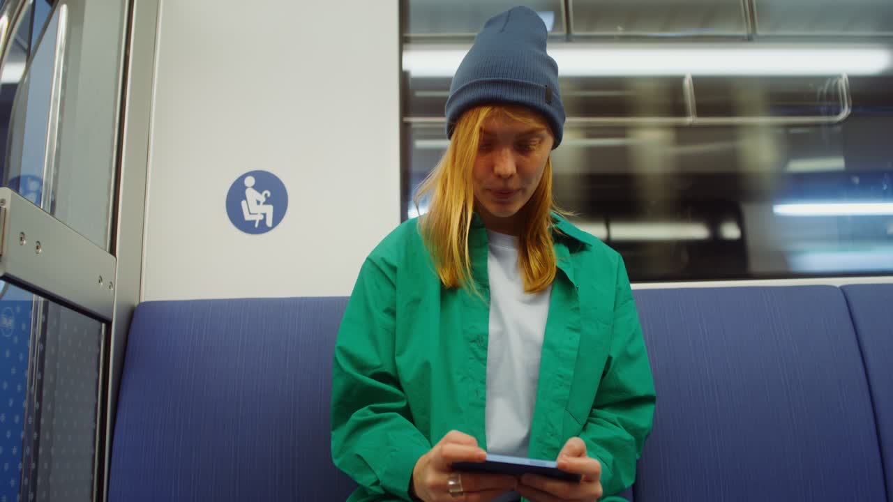Woman using mobile phone on public transport