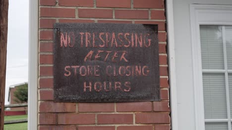 no trespassing sign at an abandoned business in an urban neighborhood slo motion