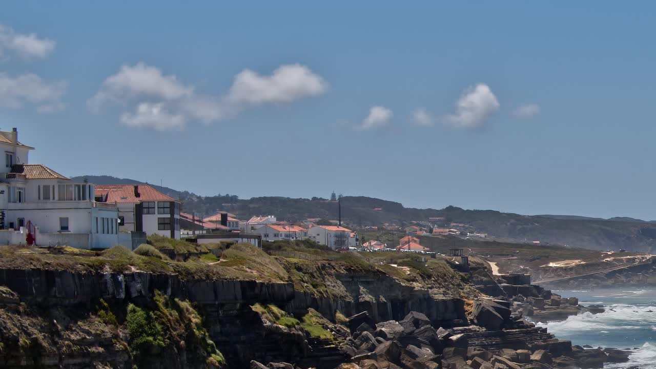 View of coastal cliffs and buildings in Portugal at midday