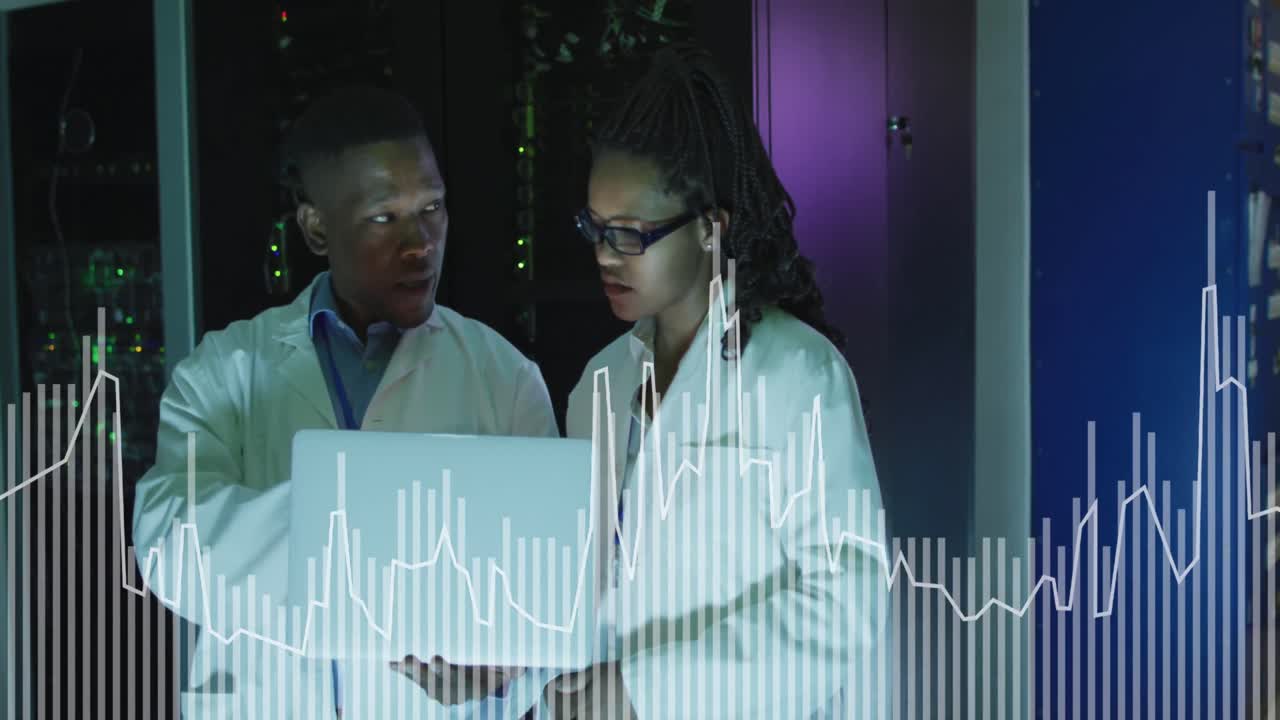 Animation of graphs over african american man and woman working on laptop in server room