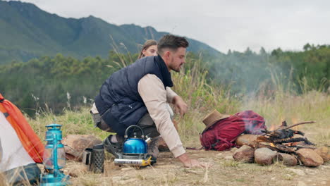 couple, camping and fire with wood