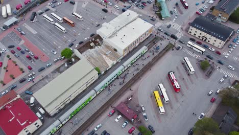 people getting in and out of the train at the harbour. drone shot