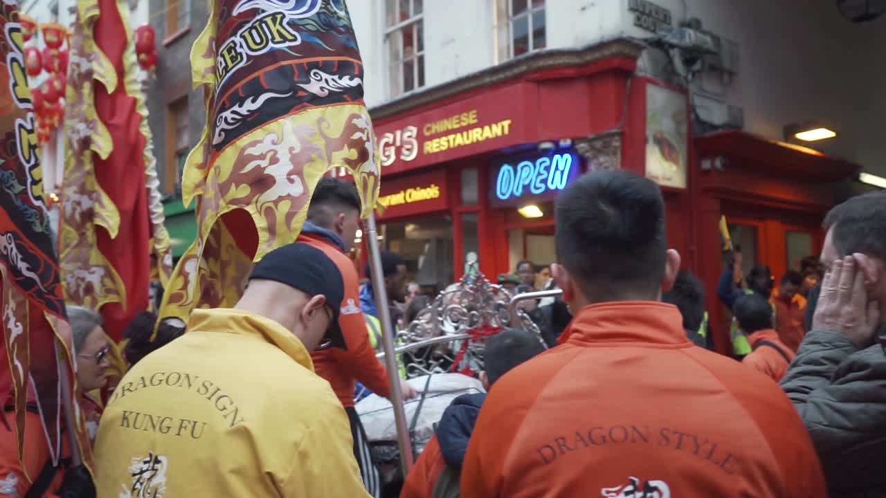 Crowded street in china town london uk with percusion band playing drums in new years celebration