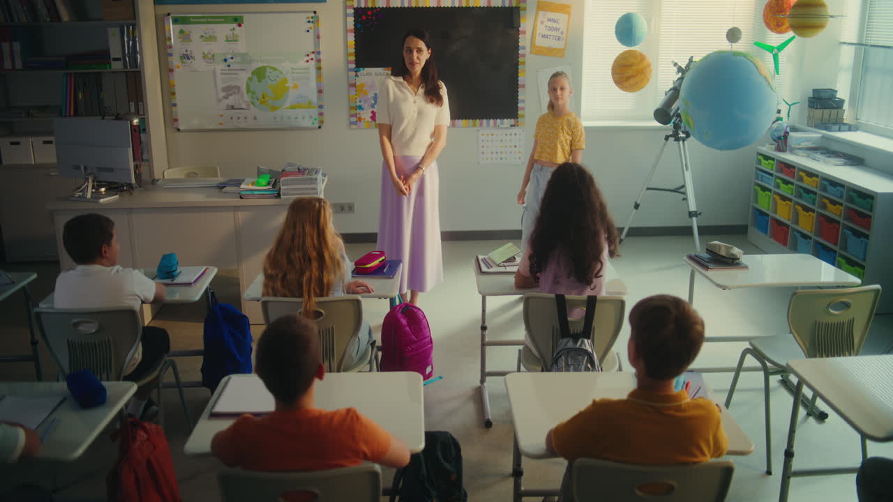 Female Teacher Calling Boy and Girl to the Board for Presenting Homework on Ecology