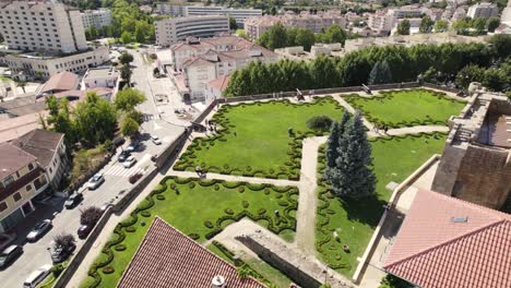 aerial circling view of gardens and cityscape from menagem tower of chaves castle in portugal