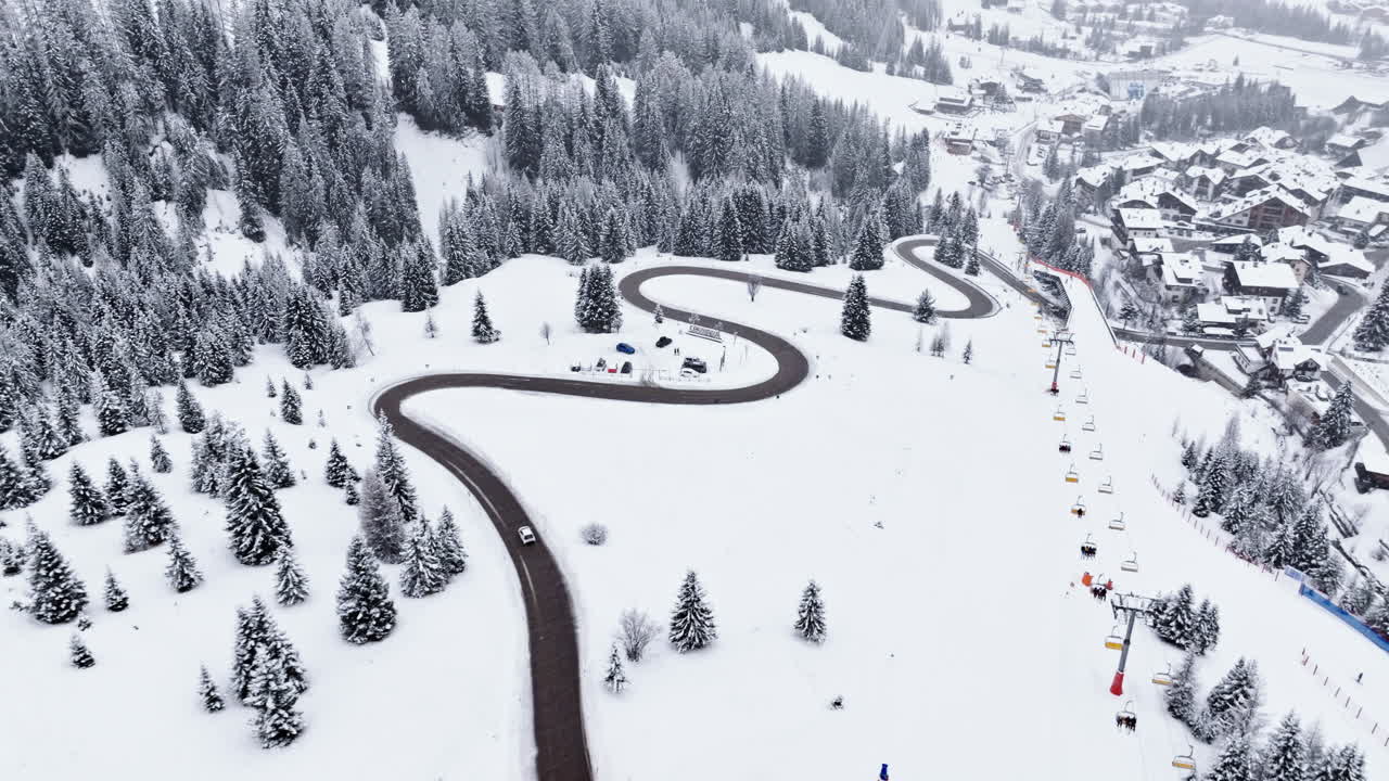 Aerial drone view of the Corvara village covered in snow, in South Tyrol, Dolomites, in northern Italy