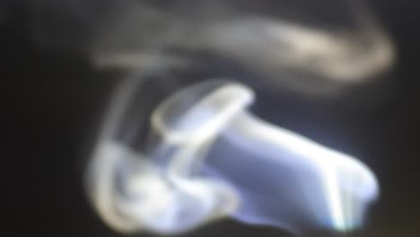 white smoke slowly floating through space against dark, atmospheric smoke, fog effect, vfx element