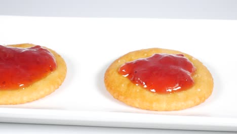 Round crackers with strawberry jam