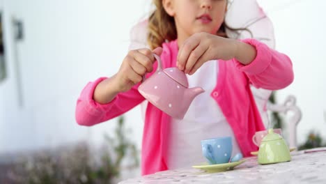 girl in fairy costume pouring tea into cup 4k