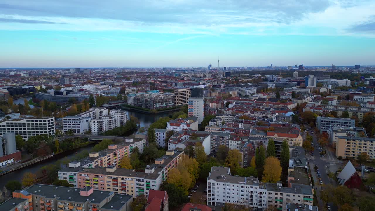 Urban skyline of car dealer in Charlottenburg, city on the Spree in Berlin showcasing a vibrant city and river at dawn. Fantastic aerial view flight static tripod hovering drone