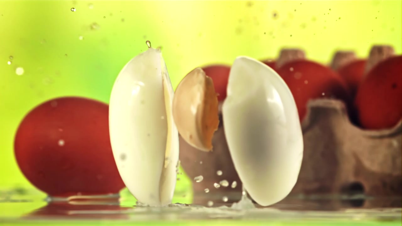 Peeled Boiled Egg Splitting in Slow Motion with Water Splashes