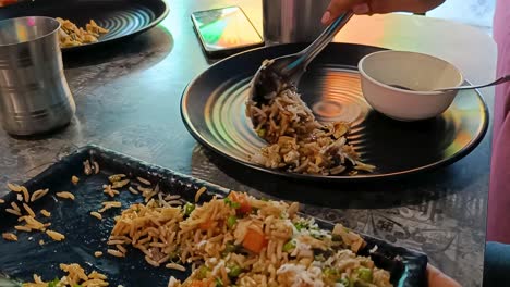 serving fried rice indian recipe on plate in a restaurant closeup look