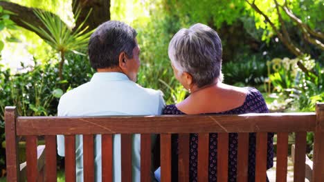 senior couple talking in garden on a sunny day