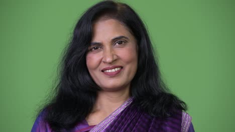 close up shot of mature happy beautiful indian woman smiling while wearing sari traditional clothes