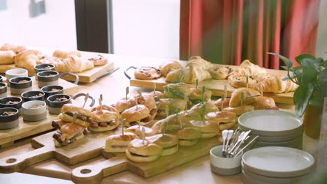 breakfast buffet spread with oats, pastries, and hot breakfast sandwiches, ready for morning indulgence