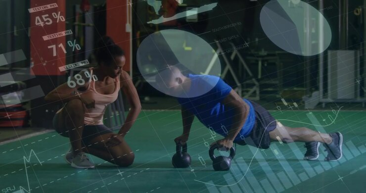 Client gripping kettlebells and assuming plank on green turf while coach overlaying fitness data