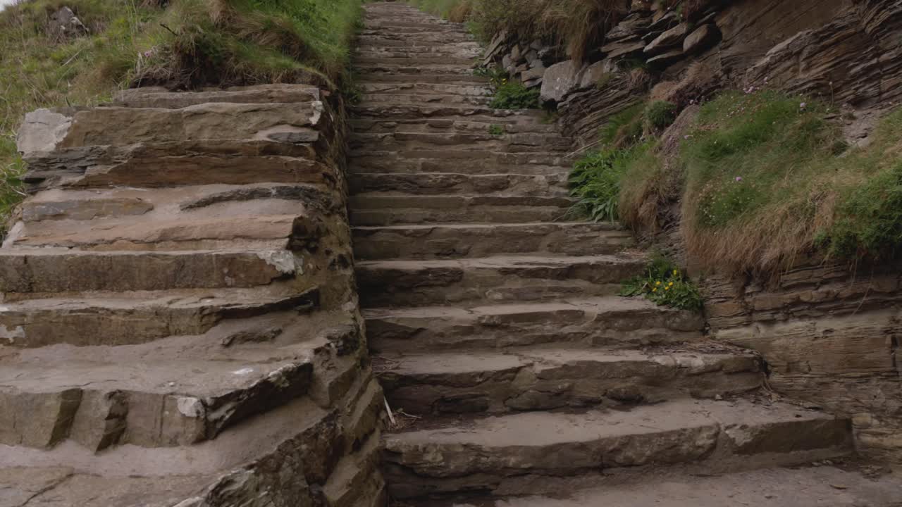 tilting shot revealing the well maintained stone stairs at the Whaligoe Steps
