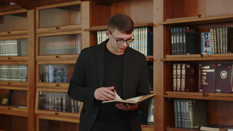 young man reading in a library