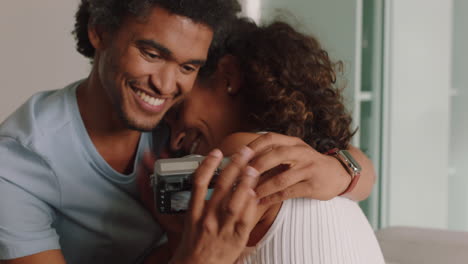 happy-couple-taking-photo-together-using-camera-having-fun-relaxing-at-home-on-sofa-enjoying-romantic-relationship