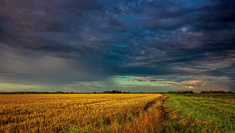 ominous grey black storm clouds turn green as they move above agriculture farmland