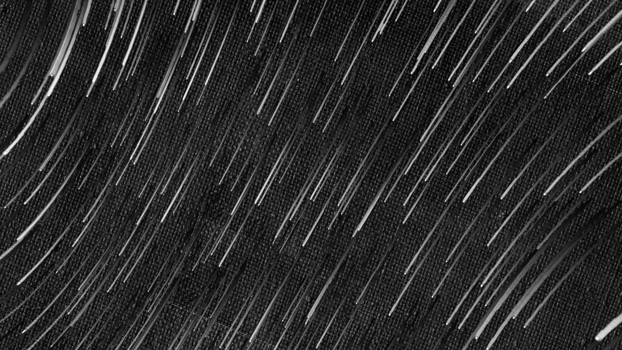 Animation of white lines falling on black background