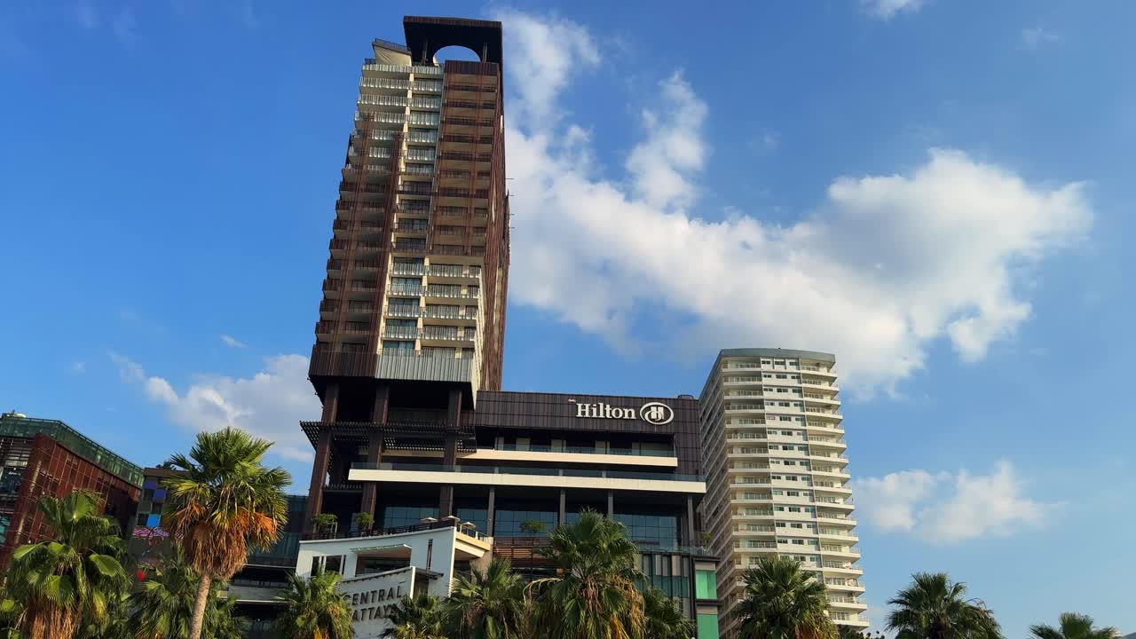 Pattaya Thailand Hilton hotel holiday building beachfront sandy beach, palm tree street