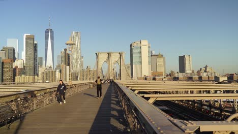 walking across the brooklyn bridge in new york city