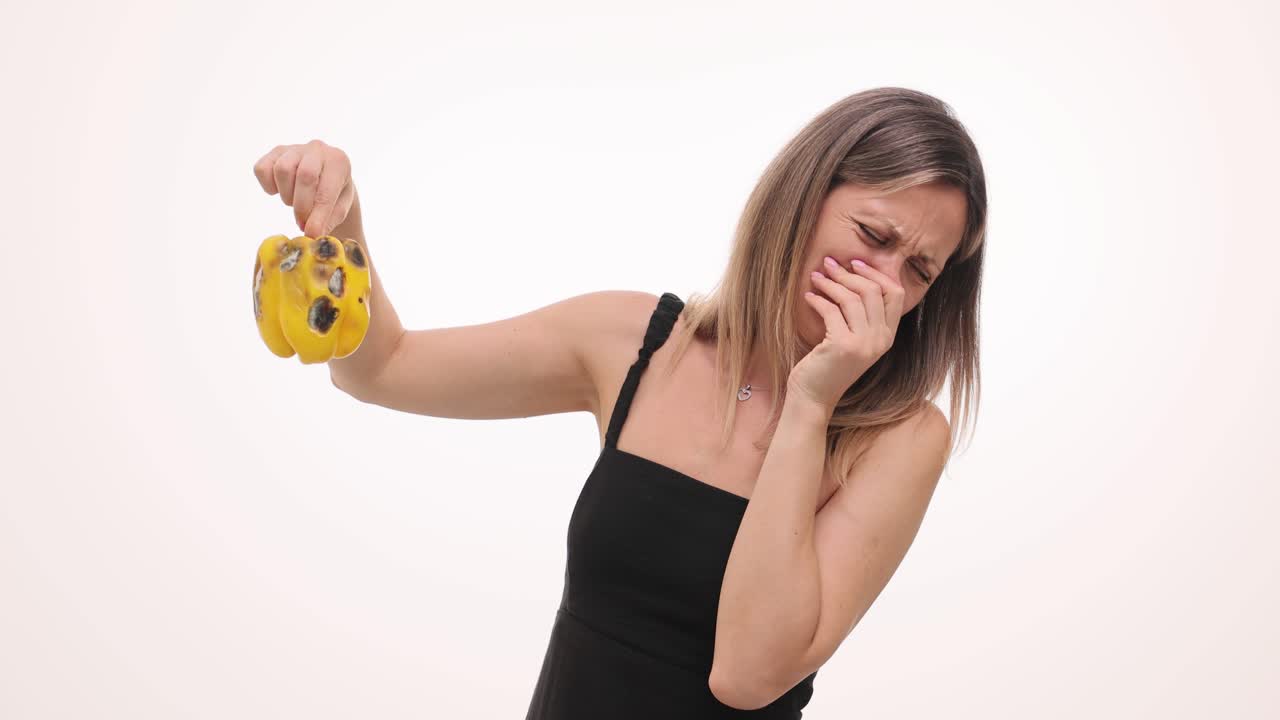 Woman disgusted by rotten pepper