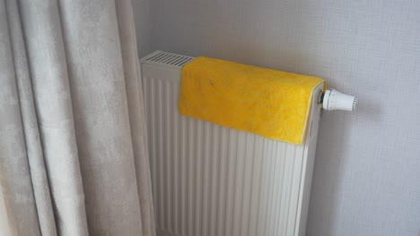 cleaning a radiator with a yellow towel