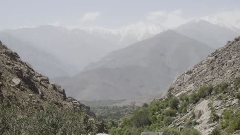 endless valley of panshir with snowy peaks in far distance, static view