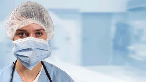 Portrait-of-female-surgeon-wearing-face-mask-against-hospital-in-background