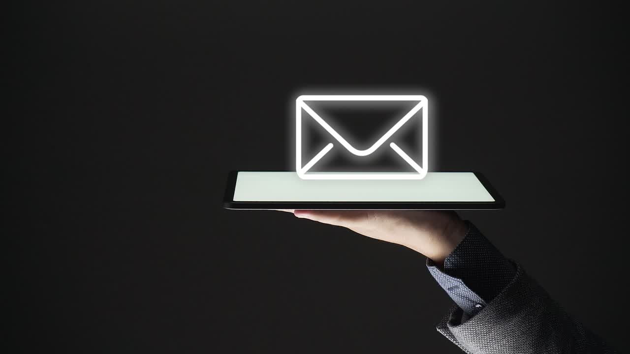 contact concept. business person shows hologram of icons for e mail, messages on blue background