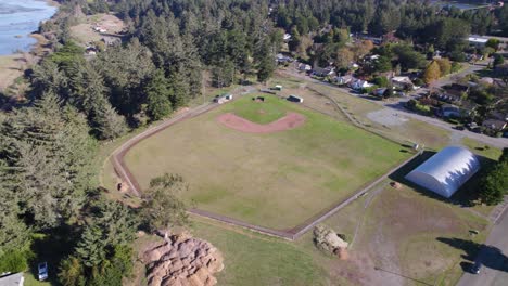 4K-aerial-drone-shot-overlooking-baseball-field-in-Bandon,-Oregon