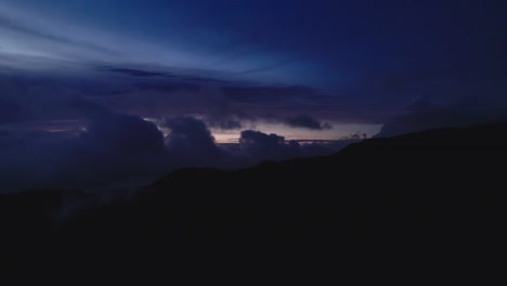 fixed drone clip above the clouds on dark ominous night