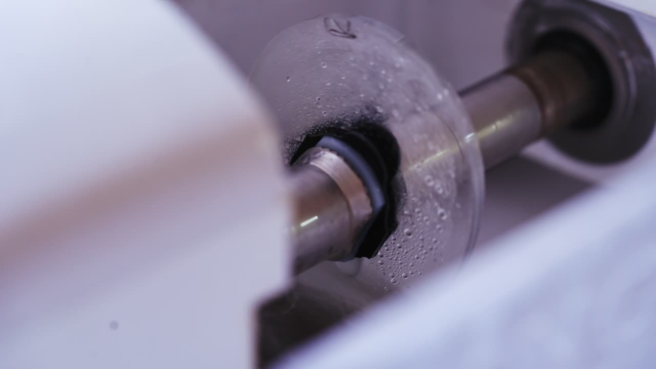 Cutting glasses lens. Man polishing glasses in optical shop