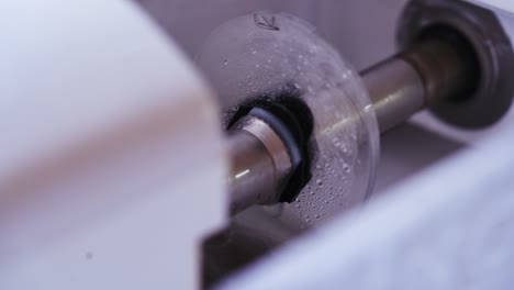 cutting glasses lens. man polishing glasses in optical shop