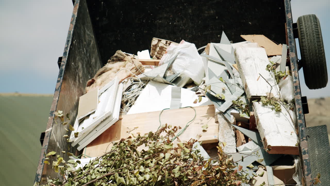 Dumpster full of mixed construction and yard waste