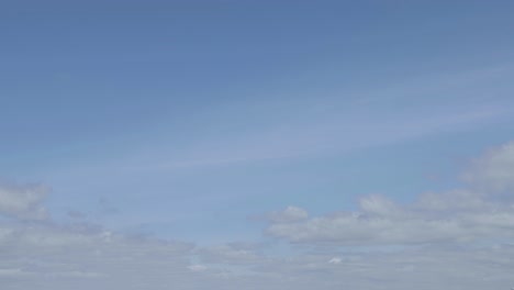 timelapse of clouds moving and rolling on a blue and sunny sky. summer time, western europe