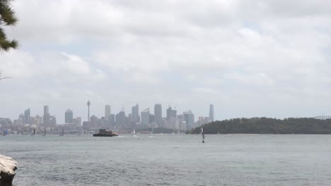 ferry crossing in front of sydney's skyline