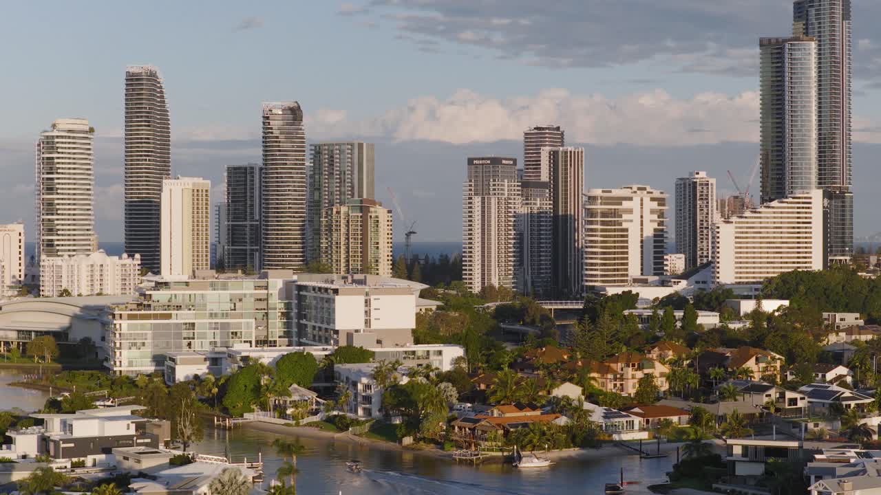 Drone footage captures the Gold Coast skyline during golden hour, highlighting skyscrapers, ocean views, and urban landscapes