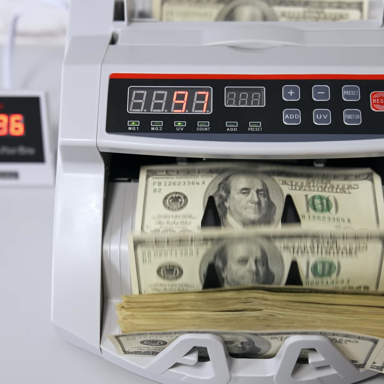 Dollari USA su una macchina contabanconote. Donna che inserisce denaro nella contabanconote.