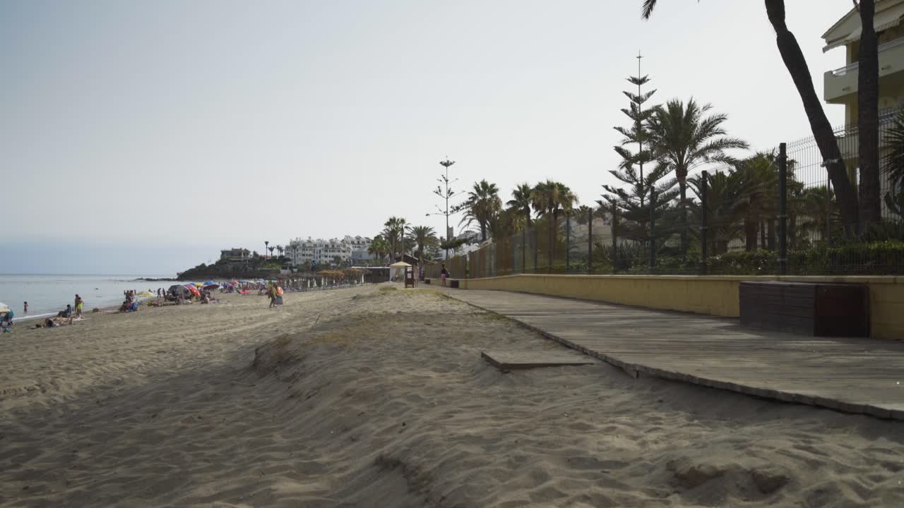 The boardwalk on the beach at Cala de Mijas on a lazy sunny afternoon