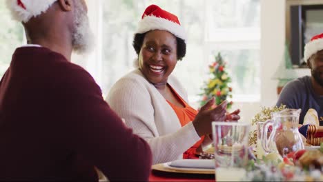 african american woman in santa hat talking and smiling